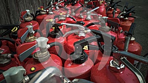 Many used fire extinguishers as background