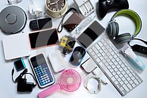 Many used modern Electronic gadgets for daily use on White floor, Reuse and Recycle concept
