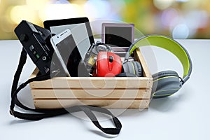 Many used modern Electronic gadgets for daily use in wooden cases on white background photo