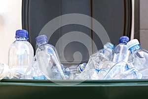 Many used plastic bottles in trash bin, closeup. Recycling problem