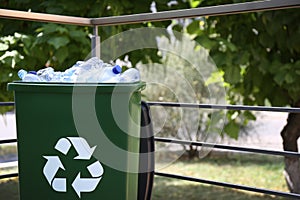 Many used plastic bottles in trash bin outdoors. Recycling problem