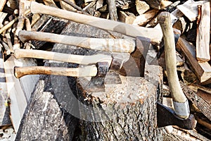 Many various axes in wooden block
