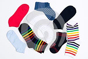 Many various colorful textile socks for warm weather. Legs clothes on white background