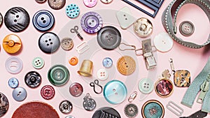 Many various sewing objects on pink background