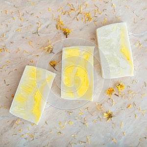 Many various white homemade bar soaps, spa bath products for skincare. Flat lay hygiene toiletries on marble table