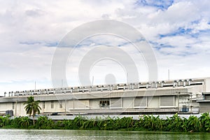 Many ventilation chimneys on the factory roof at blue sky and clouds with copy space