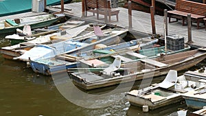 Many vintage old boats stand on the dock on river