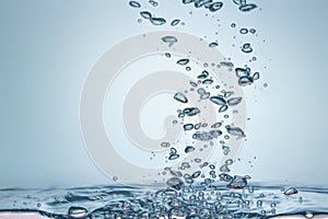 Many water droplets are both sharp and blurry. Falling on the water surface light blue