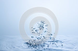 Many water droplets are both sharp and blurry. Falling on the water surface light blue