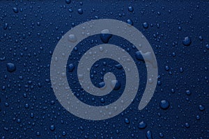 Many water drops on bright blue background