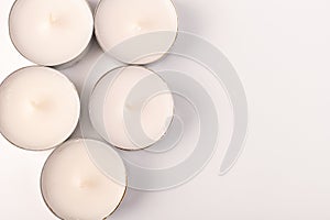 Many wax candles together on the white background