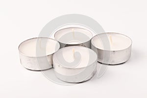 Many wax candles together on the white background