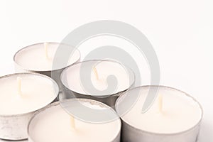 Many wax candles together on the white background