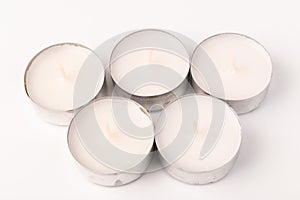 Many wax candles together on the white background