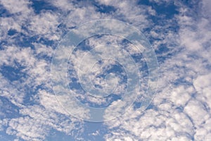 Many white clouds on a clear blue sky at sunrise