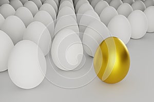 White eggs in a row with one golden egg