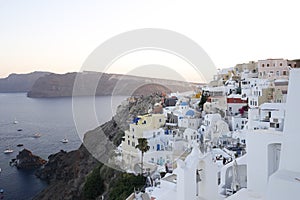 Many white houses in a cliff landscape in the volcanic Greek island of Santorini in the Oriental Mediterranean Sea