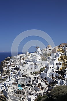 Many white houses in a cliff in Oia, Santorini, Greek Islands