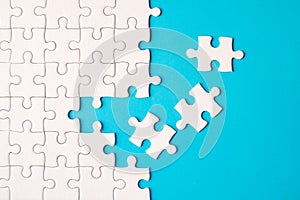 Many white jigsaw puzzle on blue background - idea solution concept