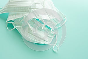 Many white medical masks. Sky blue background. Face mask protection against flu and coronavirus, pollution and virus.