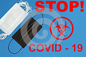 Many white and one black protective antiviral medical masks, concept of the SARS-CoV-2 virus pandemic, COVID-19, coronavirus, flu