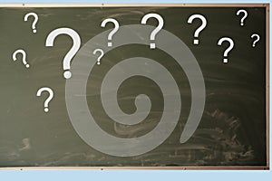 Many white question marks on a chalkboard for chalk, text, concept close-up, copy space