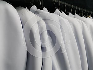 Many white shirts hanging from the clothes rack, Wedding dress rental