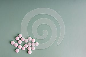 Many white tablets spilling out of package, Close up pills spilling out of pill bottle on blue background