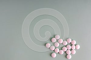 Many white tablets spilling out of package, Close up pills spilling out of pill bottle on blue background