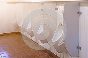 Many white urinals in the male bathroom modern style used in public health