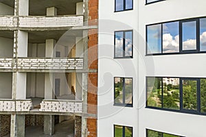 Many windows on new apartment building facade under construction