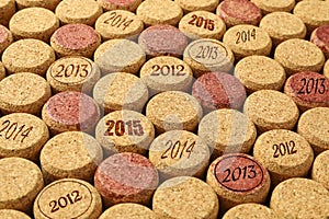 Many wine corks with different dates as background, closeup