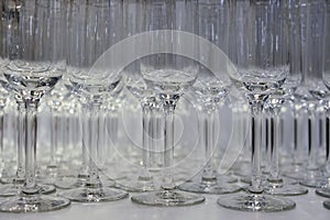 Many wine glasses on table. rows of empty wine glasses