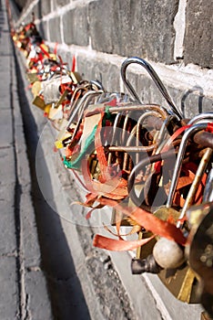 Many wish locks on the inner surface of the Great Wall of China. padlocks are hung by visitors as symbols. The Badaling area of