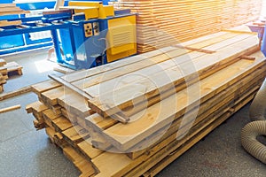 Many wooden planks stacked in carpentry workshop. Building material. Background.