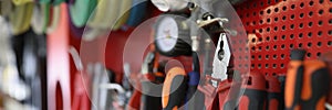 Many working tools hanging on wall in workshop closeup