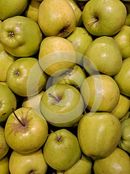 Many yellow apples form a natural background from above