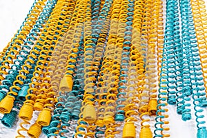 Many Yellow and blue metal coil spring equipment part of appliance machine in manufacturing process or automotive or different