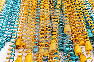 Many Yellow and blue metal coil spring equipment part of appliance machine in manufacturing process or automotive or different