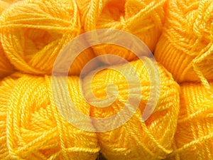 yellow colored wool thread balls, full frame, close up