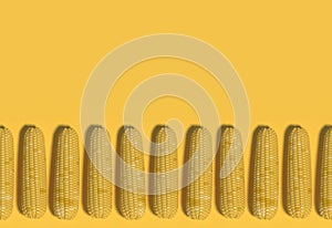 Many yellow corn cobs lie in a row on a yellow background. Creative decorative composition. Modern Art. 3D rendering.