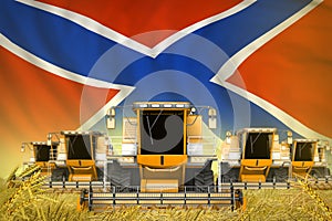 Many yellow farming combine harvesters on grain field with Novorossia flag background - front view, stop starving concept -