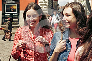 Many young happy women walking talking  on background of old european city street, stylish hipster girls having fun, moments of