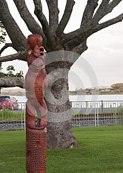 Maori carving style wood figure of Tupu a Rangi photo