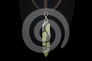 maori greenstone pounamu pendant lying on a black cloth