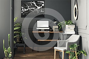 Map above desk with mockup of desktop computer in grey workspace