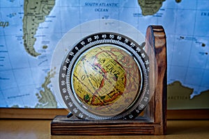 Map of Africa on an ancient globe with world map in the background