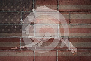 Map of alaska state on a painted flag of united states of america on a brick wall