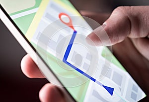 Map application in smartphone. Man navigating in city with mobile phone. photo