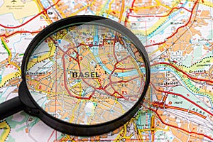 Map of Basel in Switzerland through magnifying glass, travel destination concept